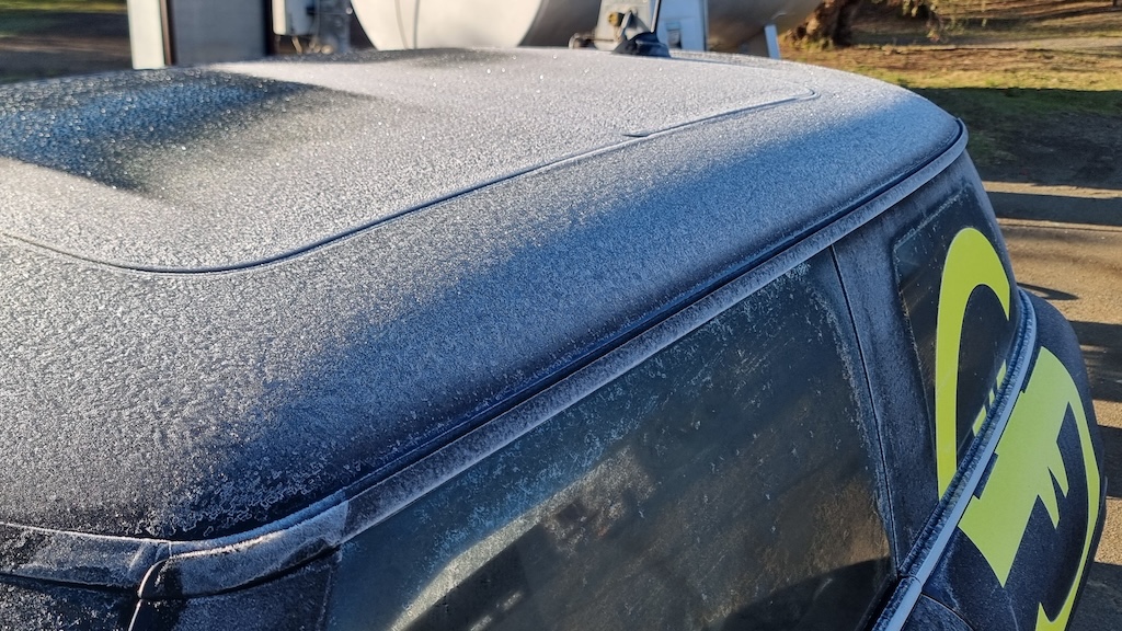 A half-frozen Whale Coast Solar Mini Cooper SE