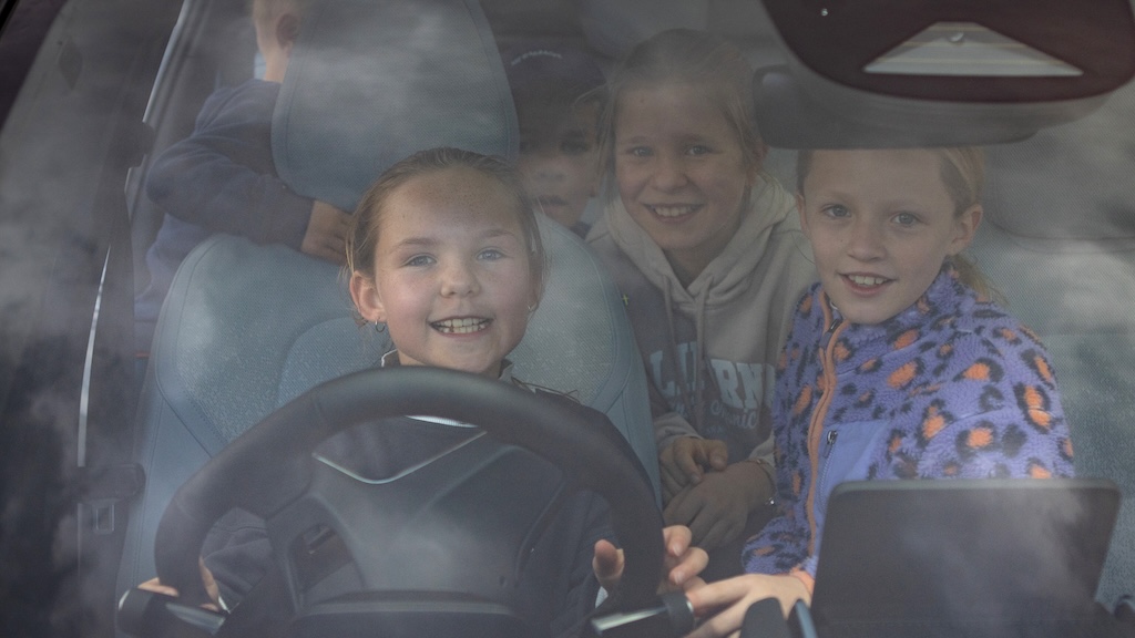 Young children behind the wheel of an EV