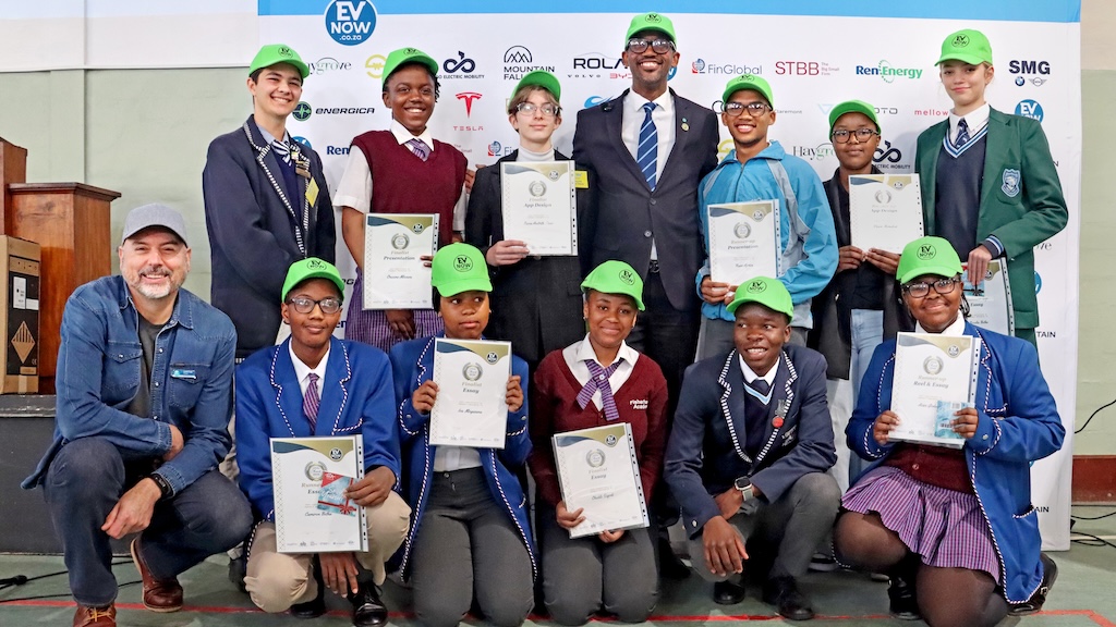 A group of learner competition finalists with an EVnow team member on the left