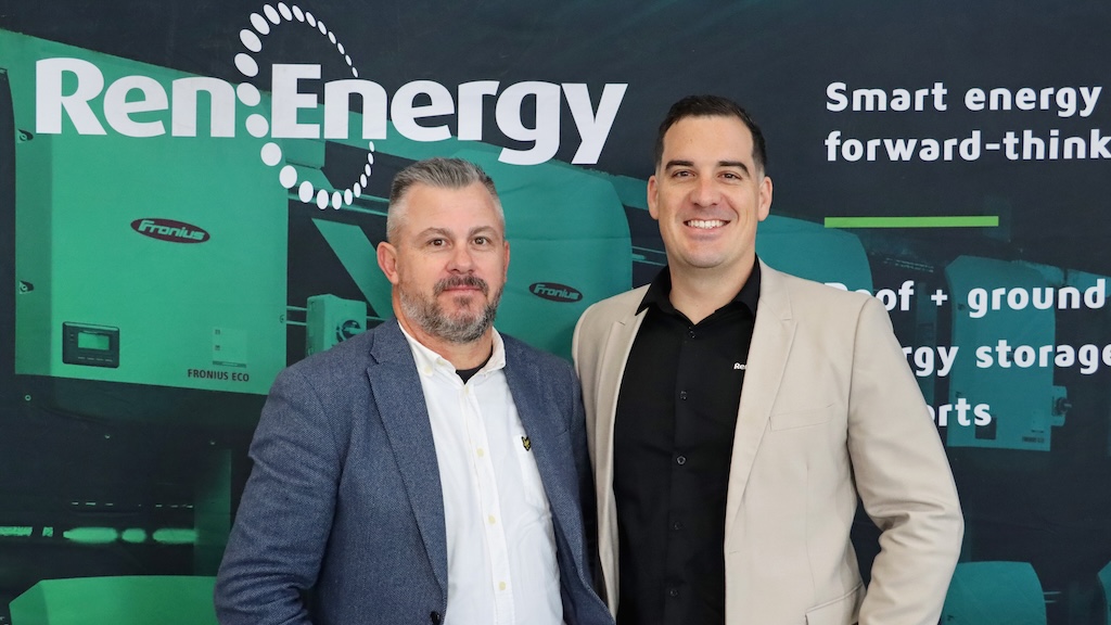 Two men in front of a RenEnergy backdrop