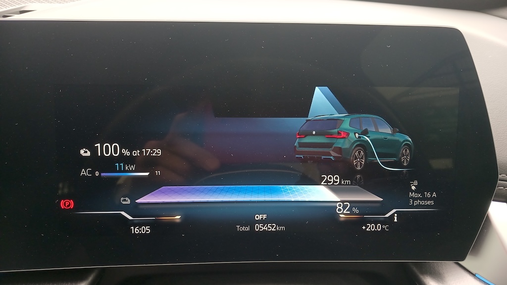A BMW iX3 showing charging progress