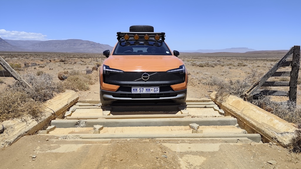 A severely damaged concrete cattle grid and the EX30 CC