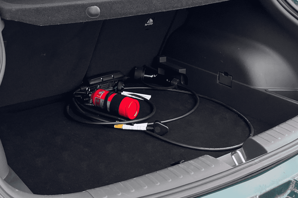 The compact 362-litre boot space configured with charging cables and emergency gear, demonstrating how everyday luggage requirements are managed.