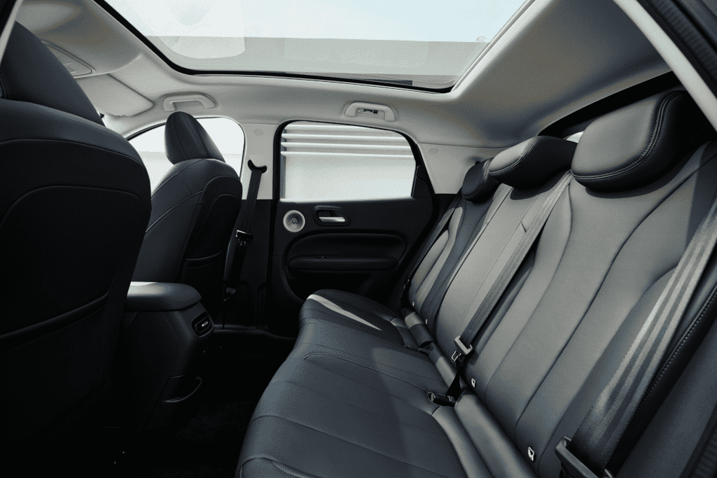 Rear passenger seating area featuring dark upholstery and dedicated air vents.