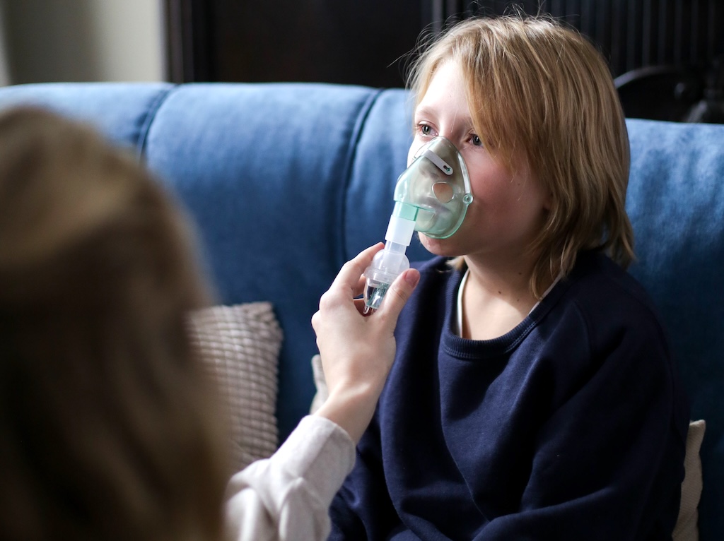 A young child assisted with breathing